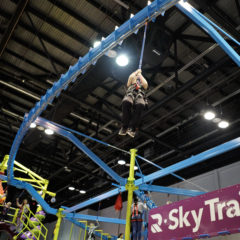 Sky-Rail-boy-participant-riding-rigid-zipline-IAAPA-RCI-Adventure-Products
