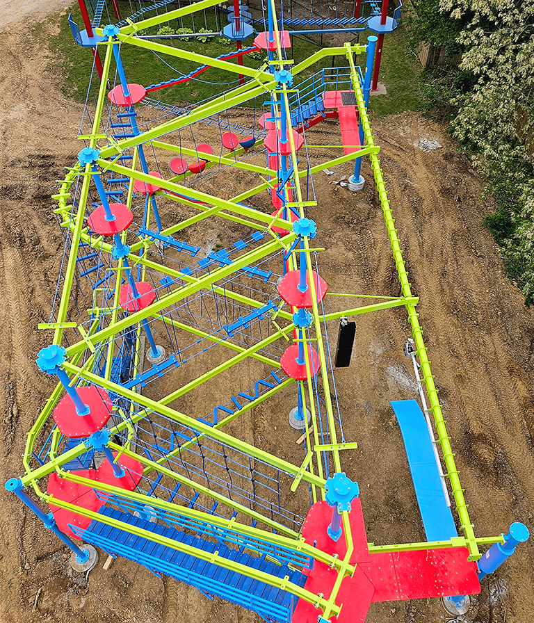 Aerial view of the large, multi-colored ropes course at Parkshore Day Camp.